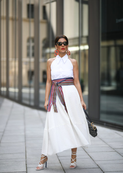 woman wearing a white dress and multi-coloured belt