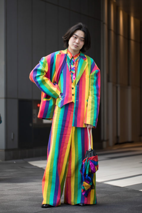 man in rainbow coloured suit inspo for what to wear to pride 2022