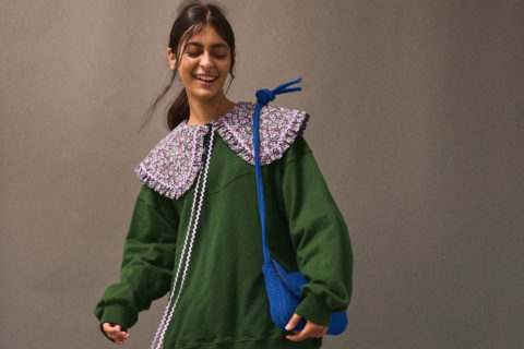 An Eliza Faulkner top in green with an oversized purple collar