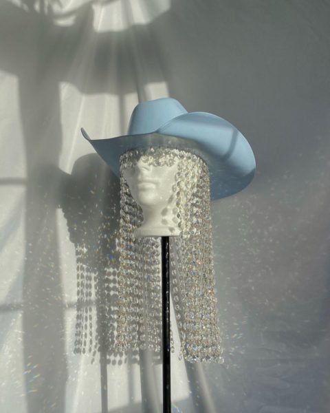 a blue cowboy hat with long beads