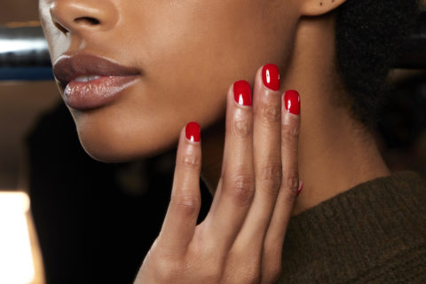 a photo of a model with red nails
