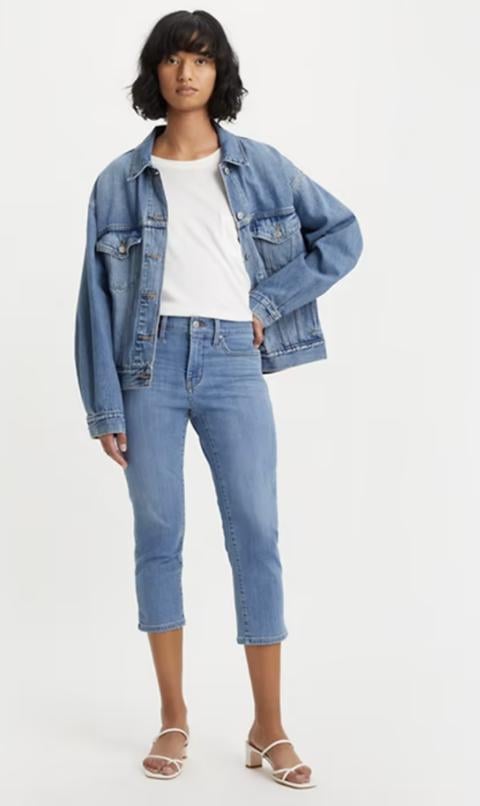 Woman wearing jean jacket and jean capris by Levi's