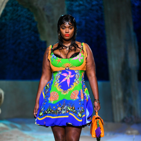 curve model precious lee walks the versace spring/summer 2021 runway in a colourful patterned dress